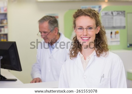 Pharmacist smiling at camera at pharmacy