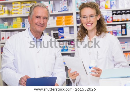 Team of pharmacists looking at camera at the hospital pharmacy