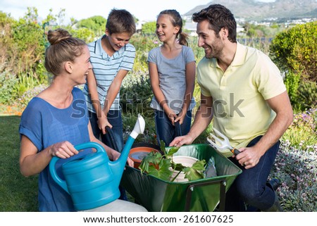 Happy young family gardening together in the garden