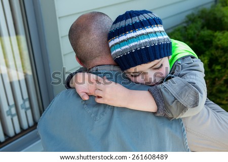 Father and son hugging in the countryside