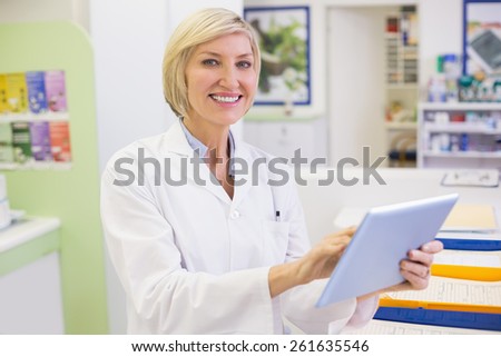 Junior pharmacist using tablet pc at the hospital pharmacy