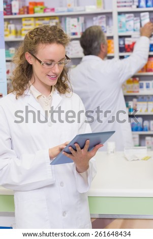 Pharmacist using tablet pc at hospital pharmacy