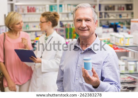 Costumer showing medicine jar at pharmacy