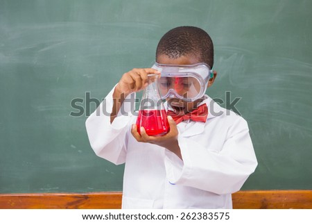 Surprise pupil looking at a red liquid at elementary school