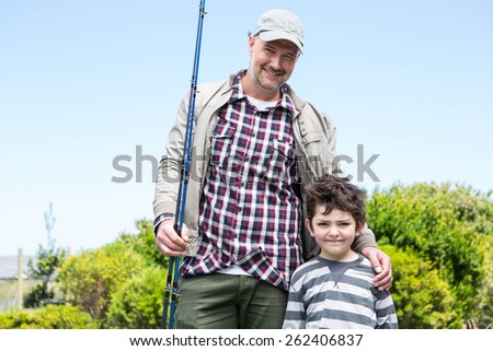 Father and son looking at camera in the countryside