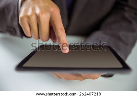 Businessman using his tablet pc in close up