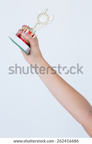 Woman holding a trophy on white background