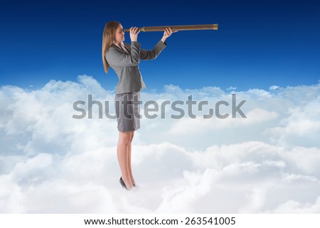 Businesswoman looking through a telescope against bright blue sky over clouds