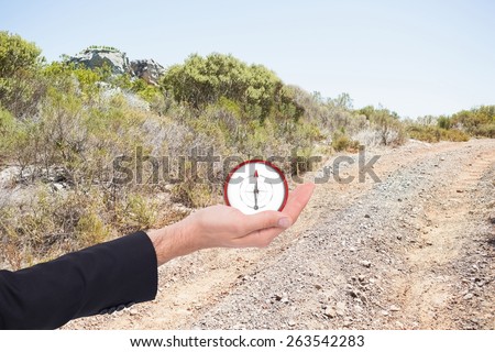 Close up of businessman with empty hand open against mountain trail