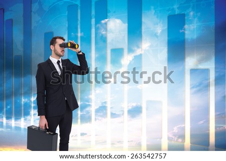 Businessman holding a briefcase while using binoculars against global business graphic in blue