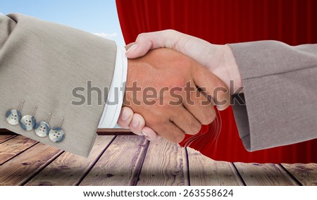 Side view of business peoples hands shaking against curtain pulled back to show harbour