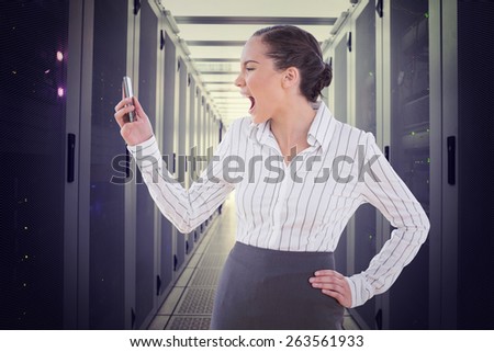 Angry businesswoman screaming at her phone against data center