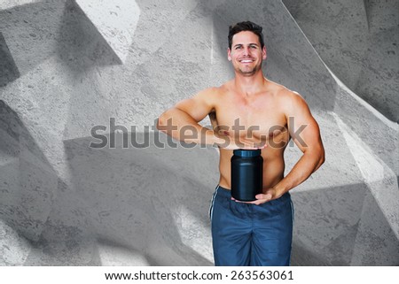 Bodybuilder with protein powder against grey angular background