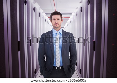 Businessman looking at the camera against data center
