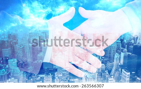 Two people going to shake their hands against high angle view of city