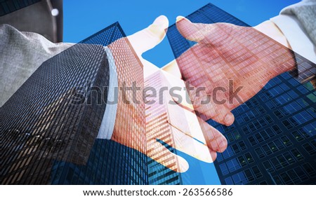 Two people going to shake their hands against skyscraper