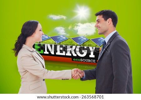 Future partners shaking hands against solar panels in a sunny field in an energy saving battery