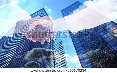 Close-up shot of a handshake against skyscraper