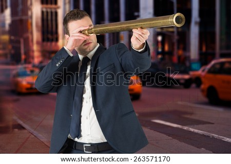 Businessman looking through telescope against blue bar chart graphic with light