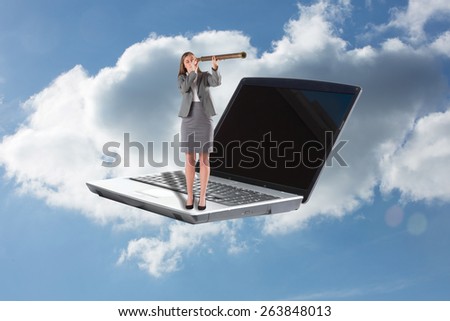 Businesswoman looking through a telescope against cloudy sky
