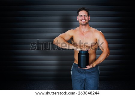 Bodybuilder with protein powder against black background