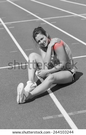 Runner with shoulder injury on track
