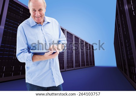Happy mature man using his tablet pc against server hallway