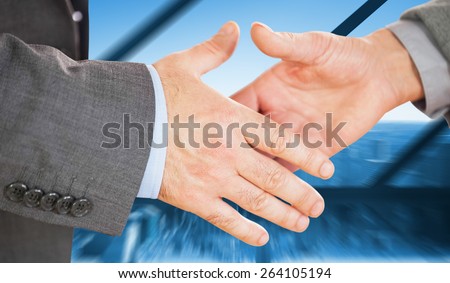 Two people going to shake their hands against room with large window looking on city