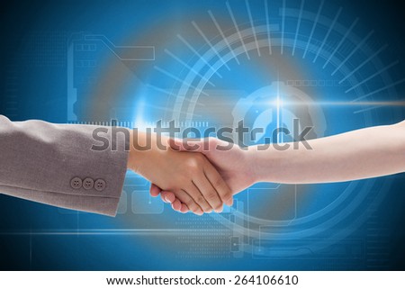 Handshake between two women against blue technology interface with dial