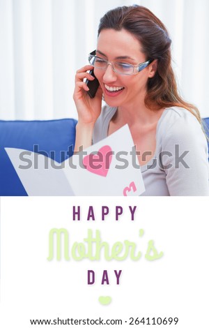 mothers day greeting against mother reading a lovely card on phone call