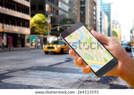 Man using map app on phone against new york street