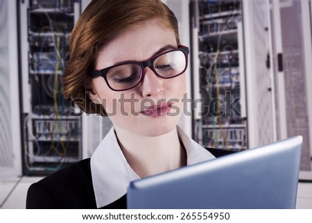 Redhead businesswoman using her tablet pc against data center