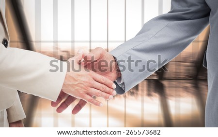 Close up of business people shaking their hands against room with large window looking on city