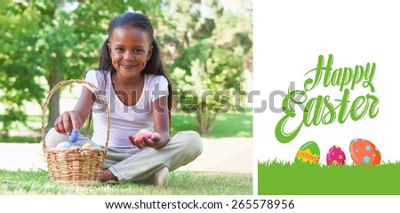 happy easter against little girl sitting on grass counting easter eggs smiling at camera