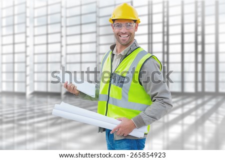 Happy architect against room with large window overlooking city