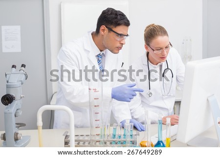 Scientists looking at computer in the laboratory