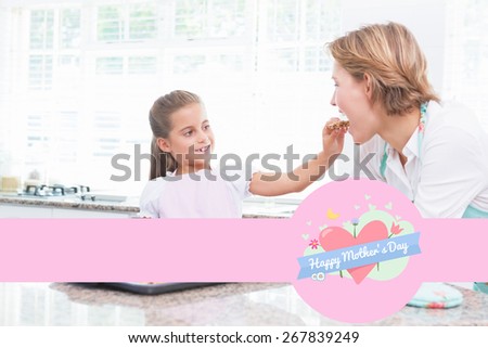 mothers day greeting against mother and daughter with hot fresh cookies