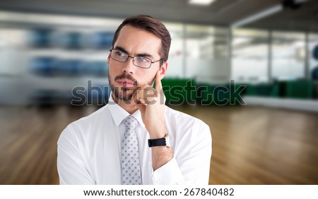 Portrait of a businessman with glasses thinking against fitness studio
