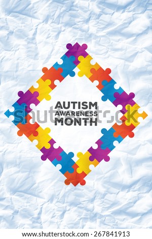 Autism awareness month against crumpled white page