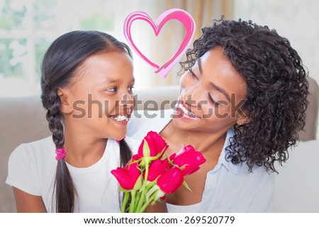 Heart against pretty mother sitting on the couch with her daughter holding roses