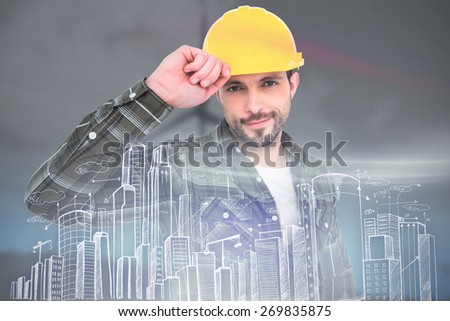 Smiling Handyman holding helmet against windmill spinning over a green field