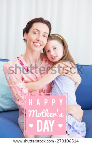 mothers day greeting against little girl with her mother on sofa