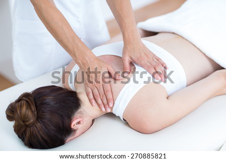 Physiotherapist doing shoulder massage in medical office
