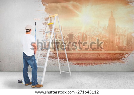 Handyman with paint roller and ladder against sun shining over city
