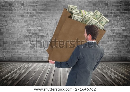 Businessman smiling with hands out against grey room