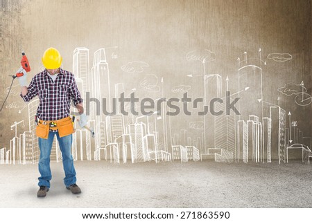 Male repairman holding drill machine and hammer against hand drawn city plan