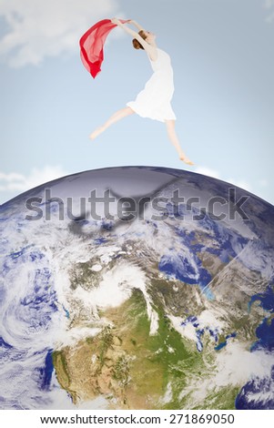Young beautiful female dancer with red scarf against blue sky