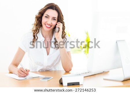Smiling businesswoman having phone call on white background