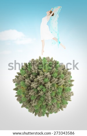 Young beautiful female dancer with blue scarf against blue sky