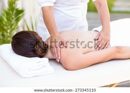 Brunette having back massage in the health spa